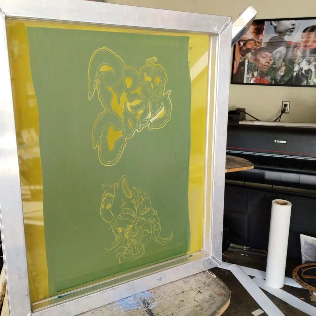 Screen printing frame with cartoon bear designs in a studio.