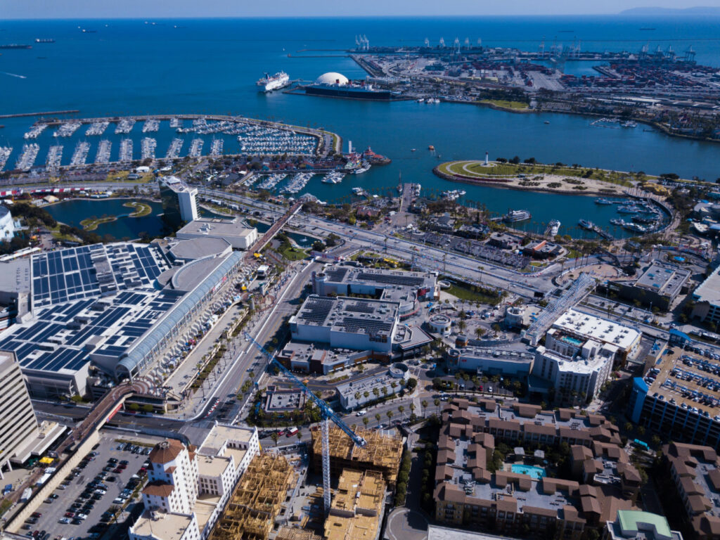 Aerial view of a coastal city with docks and residential areas.