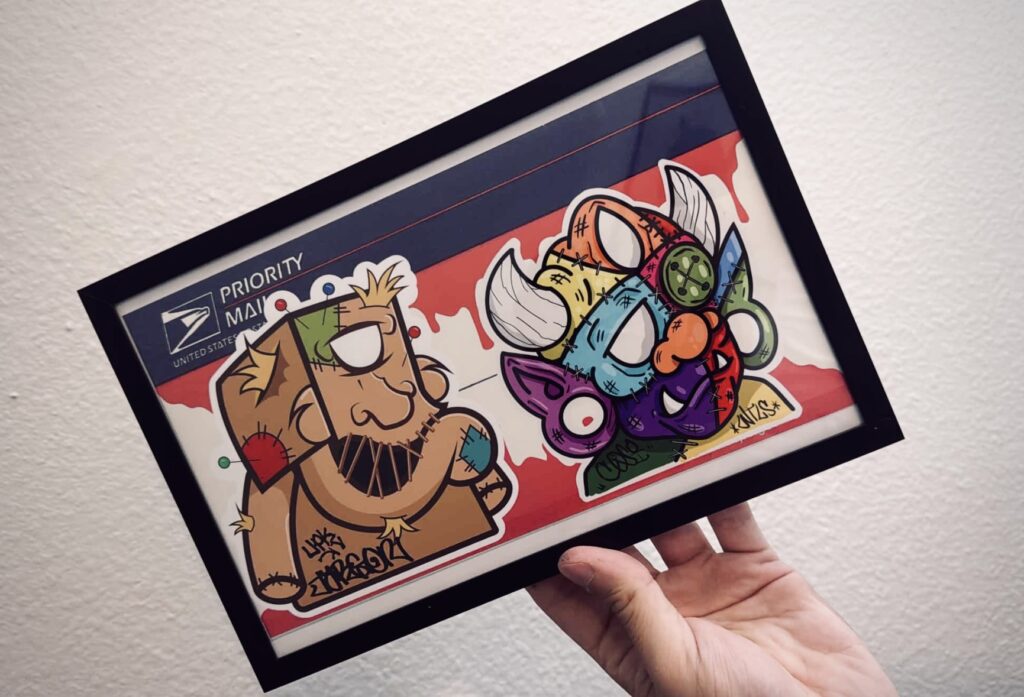 A hand holding a colorful card featuring cartoon characters Scooby-Doo and a stylized purple creature with horns.