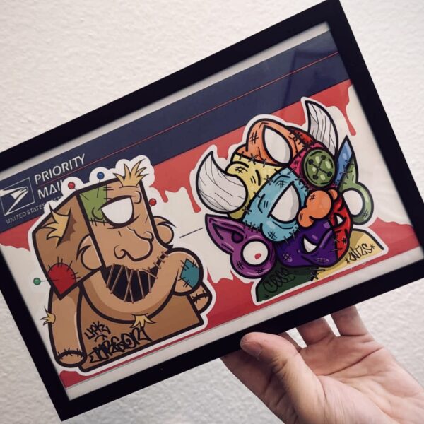 A hand holding a colorful card featuring cartoon characters Scooby-Doo and a stylized purple creature with horns.