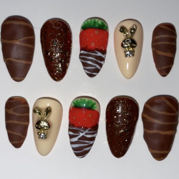 Assorted chocolate pieces with various toppings and designs.