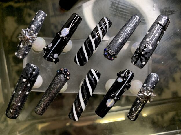 Black and silver 3D nail art designs with rhinestones.